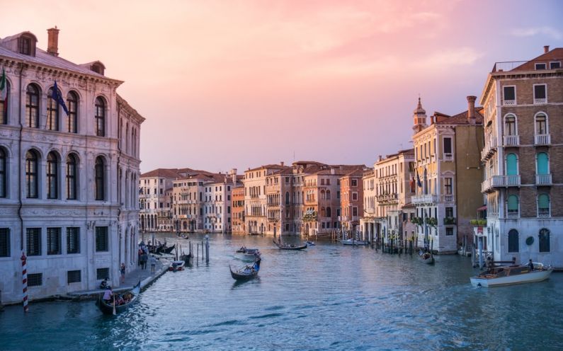 Italy Amalfi - photo of gondolas on body of water between buildings