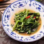 Gourmet Food Tour - a bowl of broccoli and other vegetables on a table