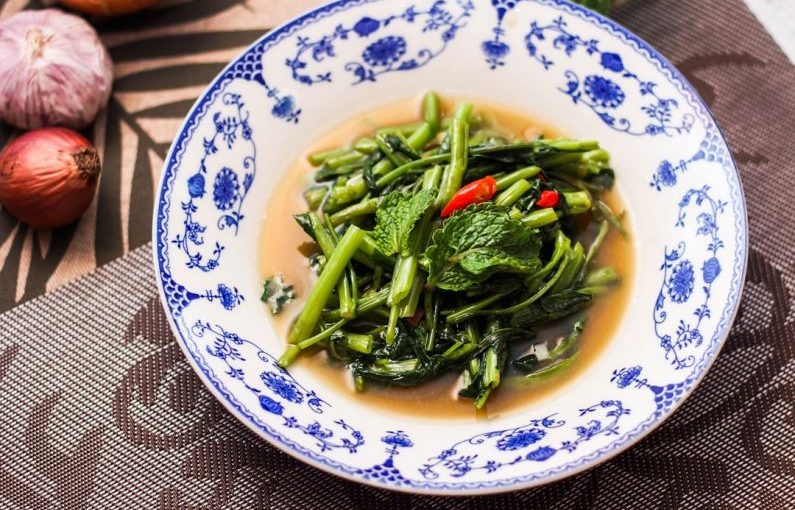 Gourmet Food Tour - a bowl of broccoli and other vegetables on a table