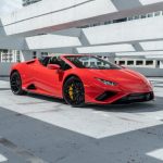 Exotic Car Rental - a red sports car parked in a parking lot