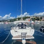 Yacht Charter - a sailboat docked in a harbor with other boats