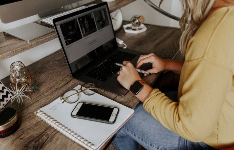 Packing List - person in blue denim jeans using macbook pro