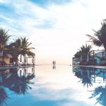 Travel Shoes - two person standing beside swimming pool