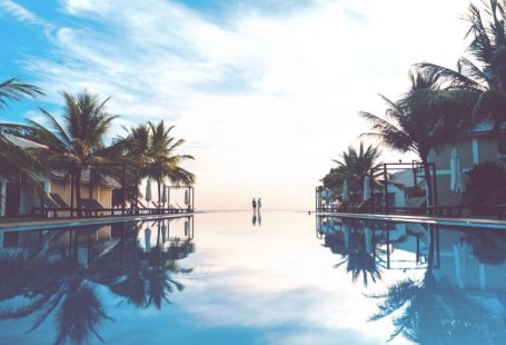 Travel Shoes - two person standing beside swimming pool