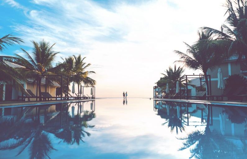 Travel Shoes - two person standing beside swimming pool