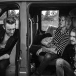 Travel Clothing - grayscale photo of three men sitting on vehicle seats