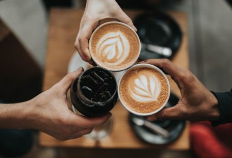 Coffee Culture - three person holding beverage cups