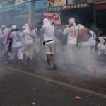 Vegetarian Travel - people in white uniform walking on street during daytime