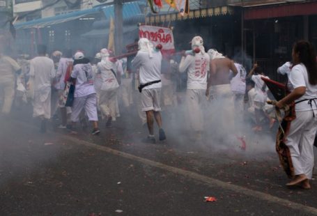 Vegetarian Travel - people in white uniform walking on street during daytime