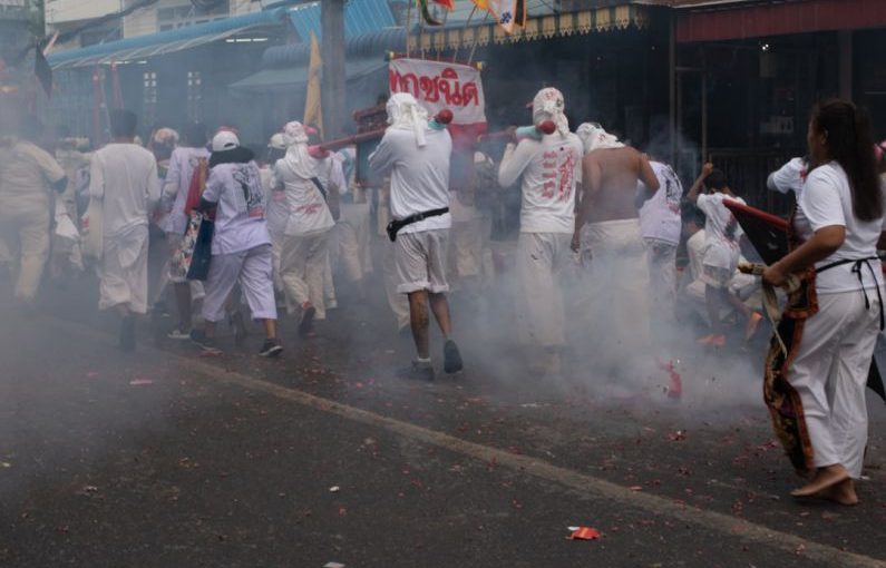 Vegetarian Travel - people in white uniform walking on street during daytime