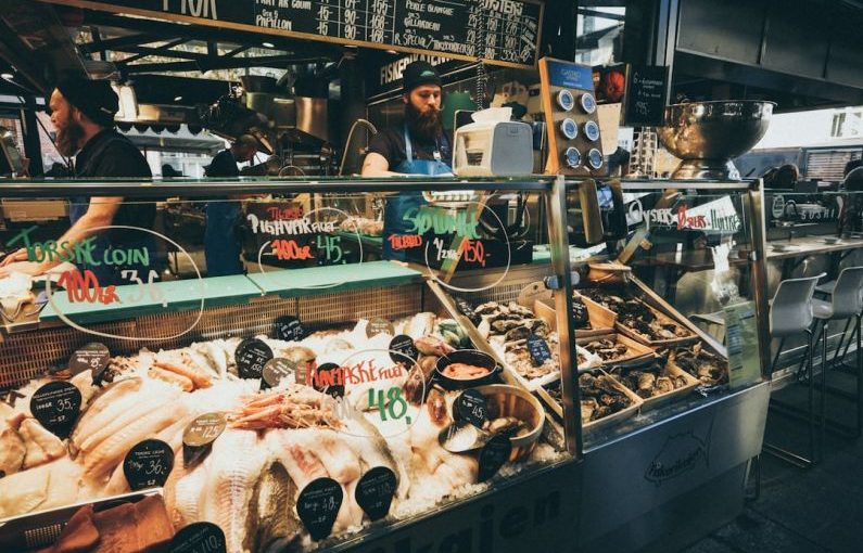 Seafood Market - man selling assorted foods