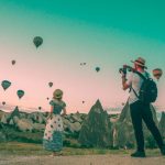 Luggage Travel - man taking photo of hot air balloons