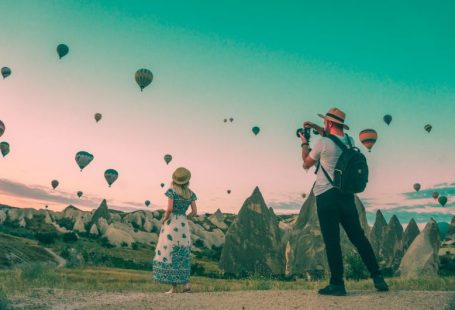 Luggage Travel - man taking photo of hot air balloons