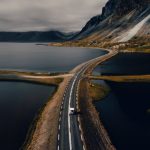 Iceland Landscape - gray concrete road near mountain during daytime