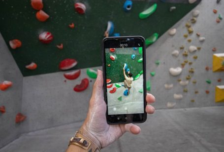 Smartphone Apps - a person taking a picture of a climbing wall