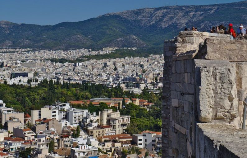 Tourist Trap - a group of people standing on top of a tall building