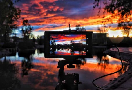 Camera Sunset - golden hour photography of body of water surrounded of trees