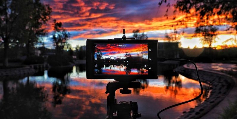 Camera Sunset - golden hour photography of body of water surrounded of trees