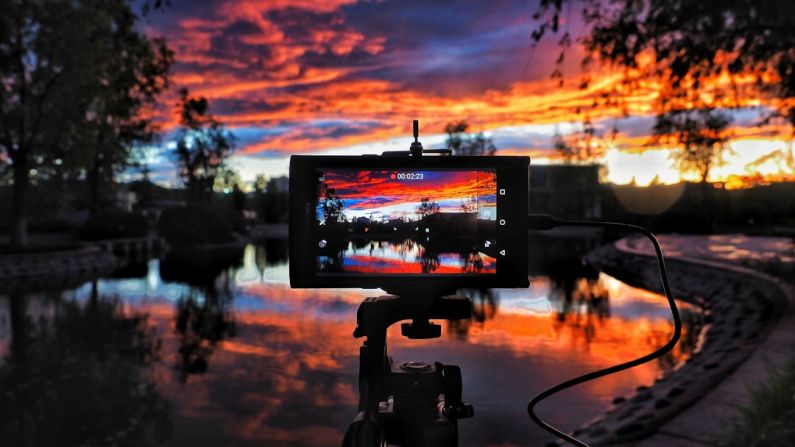 Camera Sunset - golden hour photography of body of water surrounded of trees