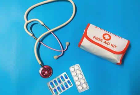 First Aid Kit - a bag of pills, a stethoscope, and a first aid kit