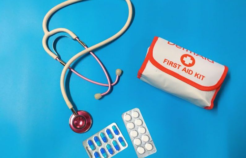 First Aid Kit - a bag of pills, a stethoscope, and a first aid kit