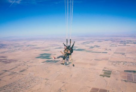 Skydiving Adventure - two men in 1 parachute in mid air during daytime