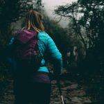 Inca Trail - woman wearing bubble jacket walking on pathway between forest