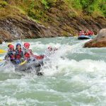 Rafting Adventure - a group of people are rafting down a river