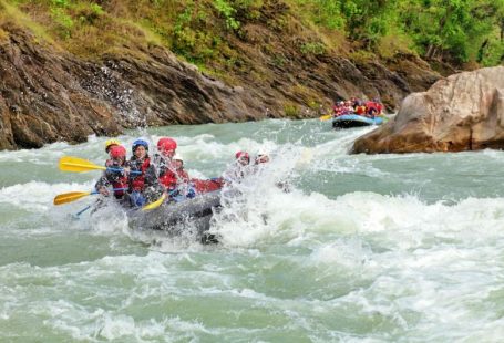 Rafting Adventure - a group of people are rafting down a river