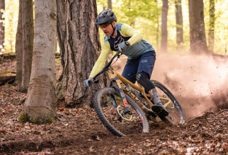 Mountain Biking - a man riding a mountain bike through a forest