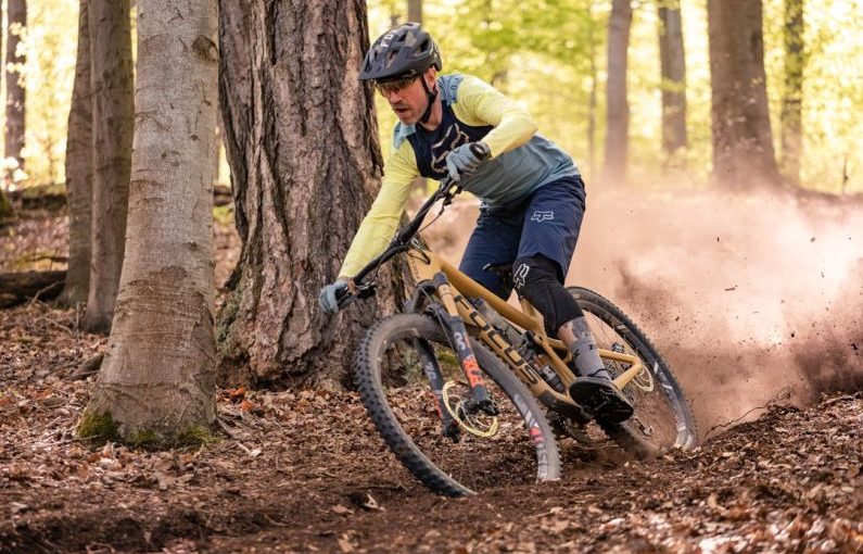 Mountain Biking - a man riding a mountain bike through a forest