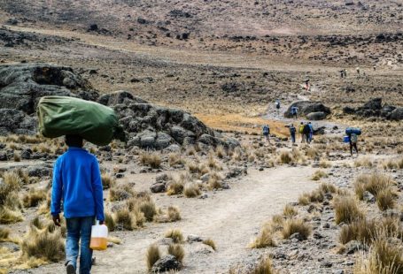 Kilimanjaro Climb - man carrying green sack
