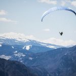 Paragliding Mountains - person doing xtreme sports parachute