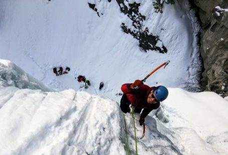 Ice Climbing - man wearing long-sleeved shirt climbing on mountain