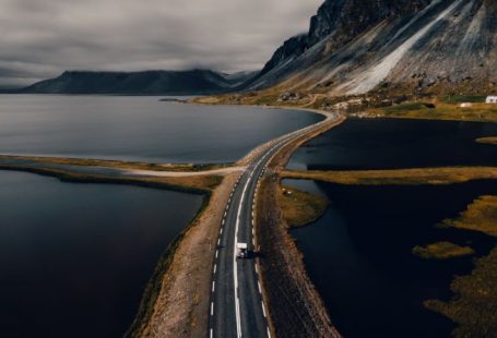 Iceland Landscape - gray concrete road near mountain during daytime