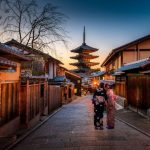 Female Solo Travel - two women in purple and pink kimono standing on street