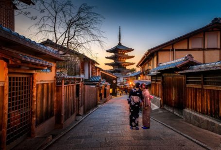 Female Solo Travel - two women in purple and pink kimono standing on street