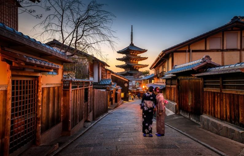 Female Solo Travel - two women in purple and pink kimono standing on street