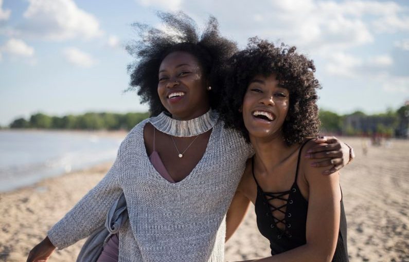 Traveler Friends - photo of woman beside another woman at seashore
