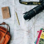 Backpack Trip - flat lay photography of camera, book, and bag