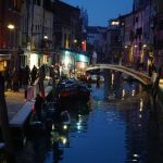 Local Cuisine - a canal in a city at night with a bridge over it