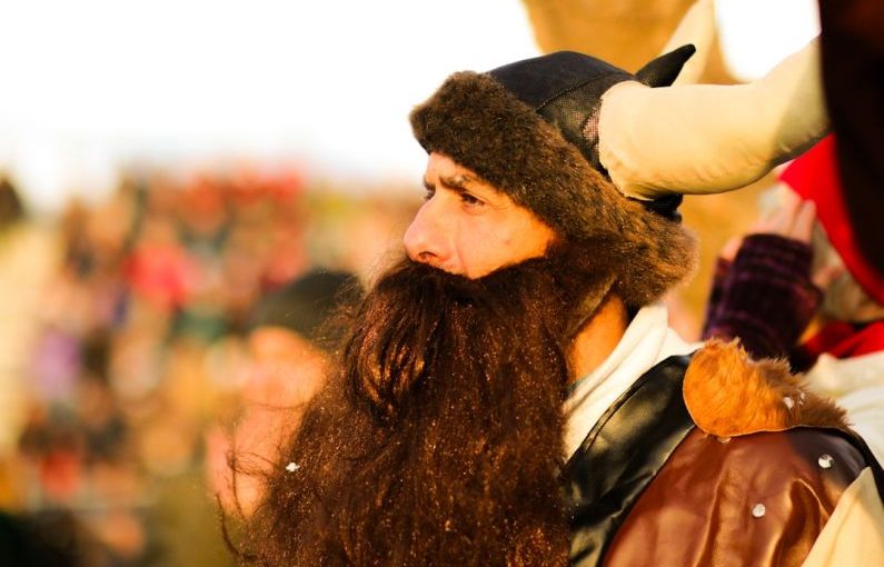 Cultural Clothing - a man with long hair and a beard wearing a horned hat