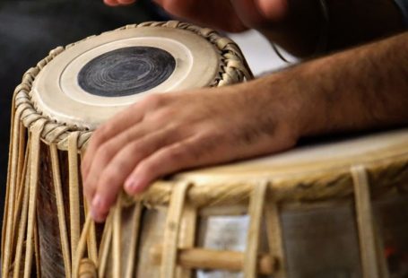 Traditional Music - a close up of a person playing a musical instrument