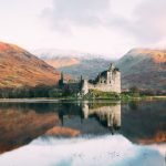 Scotland Highlands - gray concrete building near lake under white sky during daytime