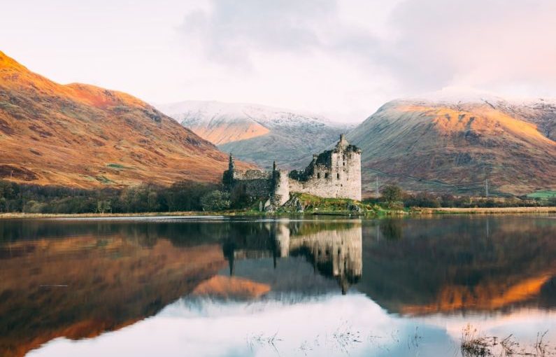 Scotland Highlands - gray concrete building near lake under white sky during daytime