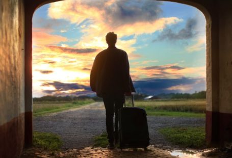 Sustainable Travel - man holding luggage photo