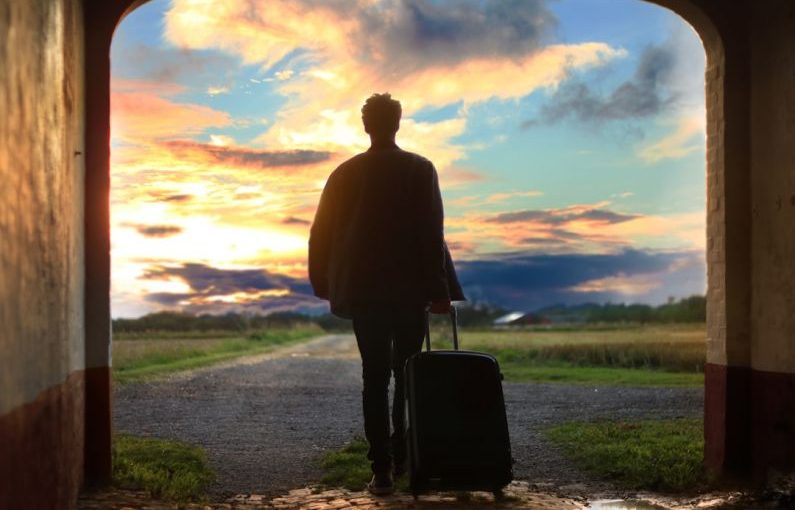 Sustainable Travel - man holding luggage photo