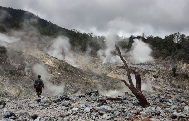 Eco Adventure - a man standing in a rocky area with steam coming out of the ground