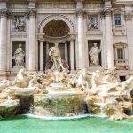 Budget Travel - a fountain in front of a building with statues on it