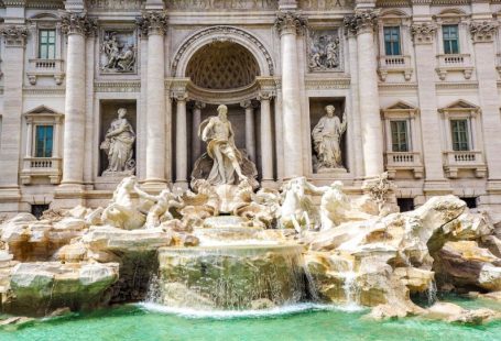 Budget Travel - a fountain in front of a building with statues on it